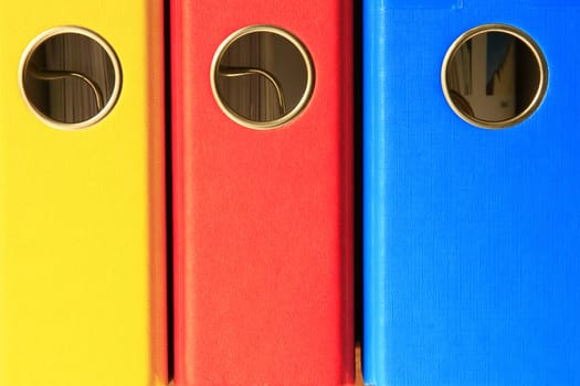 three coloured file folders