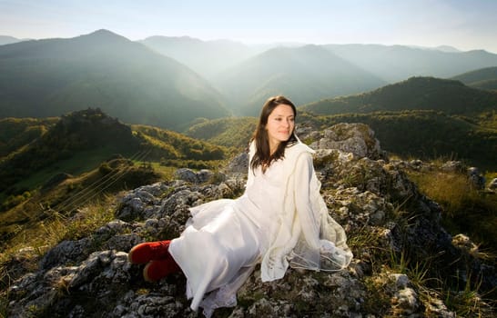 Beautiful bride posing on rocks