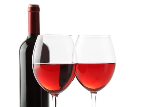 Two glasses of red wine and a bottle