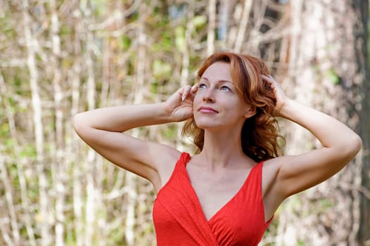 Portrait of red-haired adult woman in na