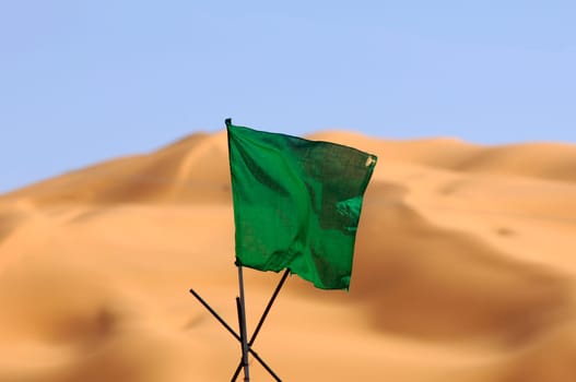 National flag of Libya in front of Saharan sand dunes,Ubari Sand Sea,Libya