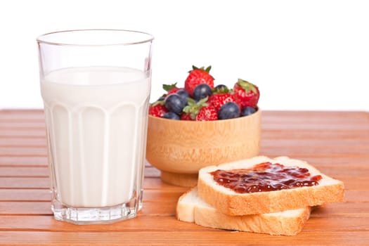 Two toast with jam, blueberries and strawberries