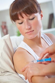 doctor injecting syringe to patient