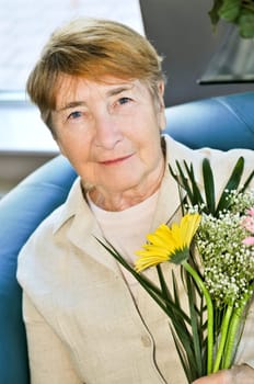 Elderly woman with flowers