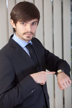 man pointing to watch