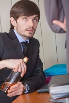 businessman drinking by the work