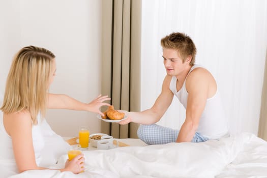 Luxury hotel honeymoon breakfast - couple in bed