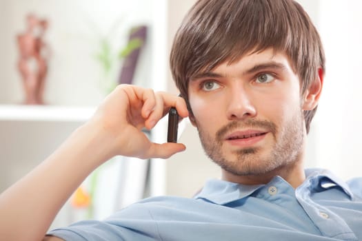 man with cell phone on sofa