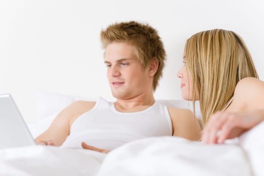 Bedroom - young couple with laptop