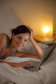 Bedroom evening - woman with laptop
