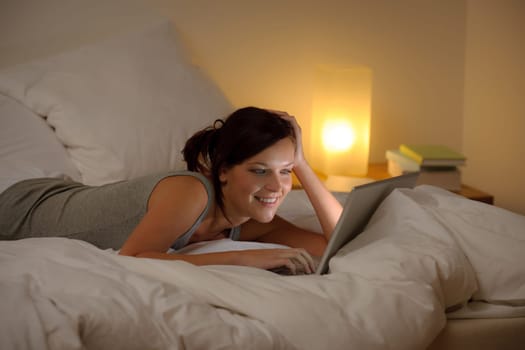 Bedroom evening - woman with laptop