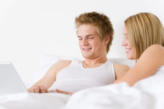 Bedroom - young couple with laptop