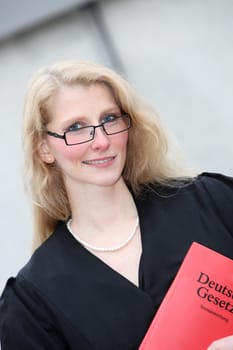 Young female lawyer with law book
