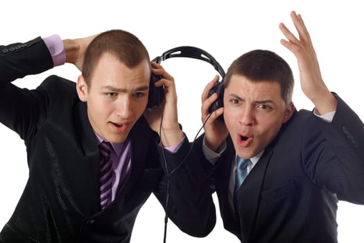 Two young people listening on headphone about something and wondering