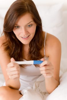 Pregnancy test - happy surprised woman