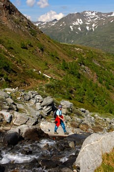Crossing a stream in the high mountains,Switzerland