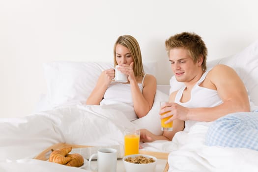 Luxury hotel honeymoon breakfast - couple in bed