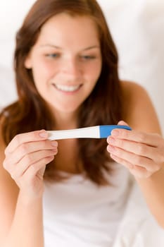 Pregnancy test - happy surprised woman