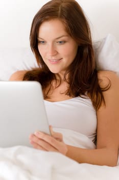 Touch screen tablet computer - woman in bed