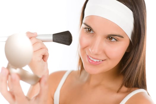 Skin care - young woman apply powder