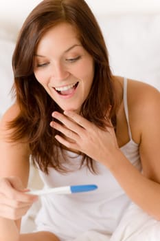 Pregnancy test - happy surprised woman