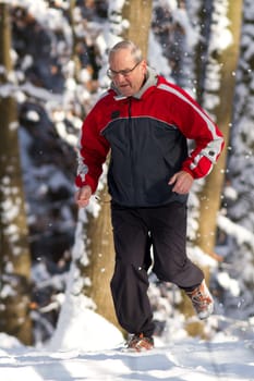 Senior jogging in the snow
