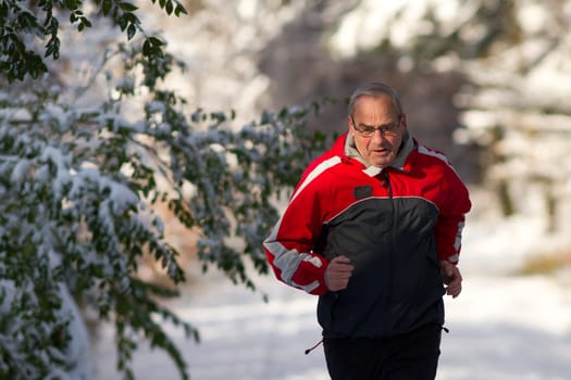 Senior jogging in the snow