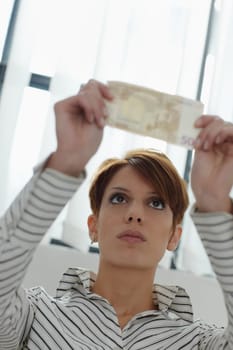 businesswoman checks banknote watermark
