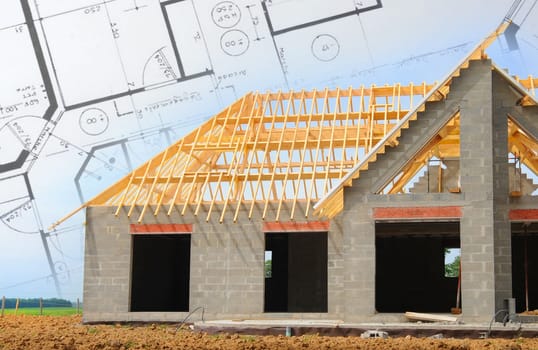 House under construction with plans