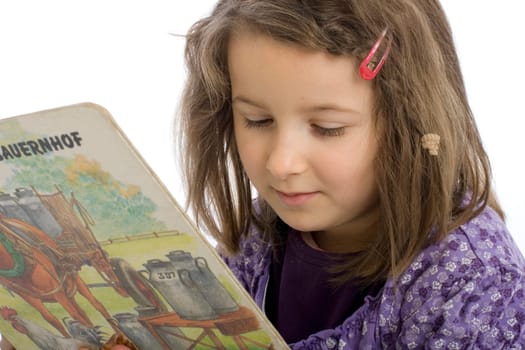 six-year-old girl reads a book (mr)