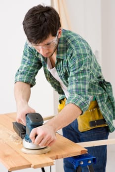 Home improvement - handyman sanding wooden floor