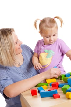 little girl and her mother playing with toy blocks