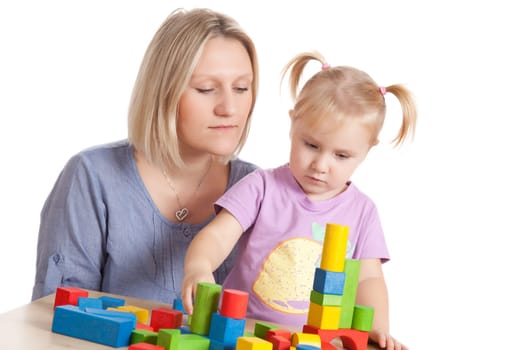 little girl and her mother playing with toy blocks