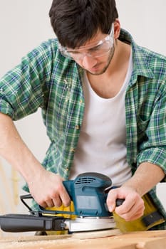 Home improvement - handyman sanding wooden floor