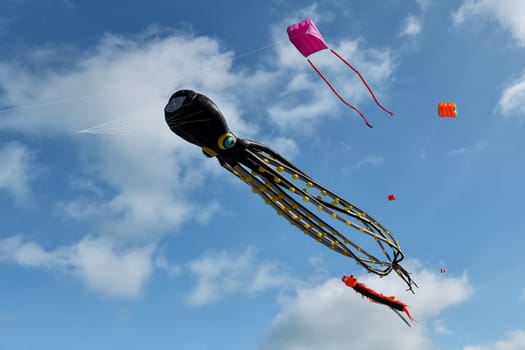 Kite festival. Octopus kites in the sky in the Atlantic ocean