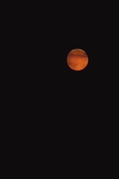 orange moon in the dark sky at night, copy space