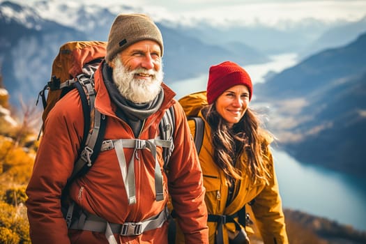 Portrait of a happy retired couple traveling in the mountains in autumn. High quality photo