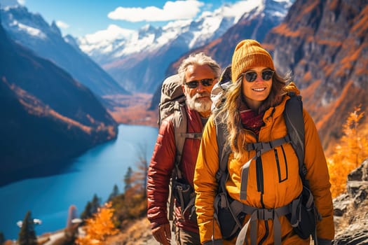 Portrait of a happy retired couple traveling in the mountains in autumn. High quality photo