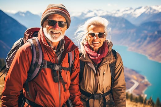 Portrait of a happy retired couple traveling in the mountains in autumn. High quality photo