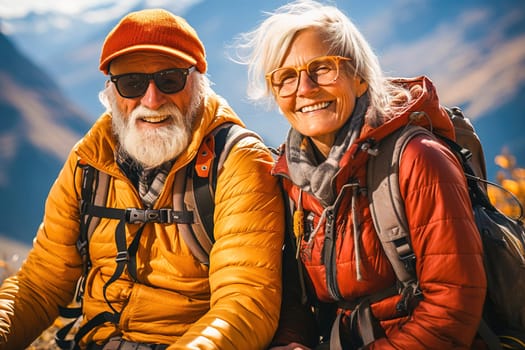 Portrait of a happy retired couple traveling in the mountains in autumn. High quality photo