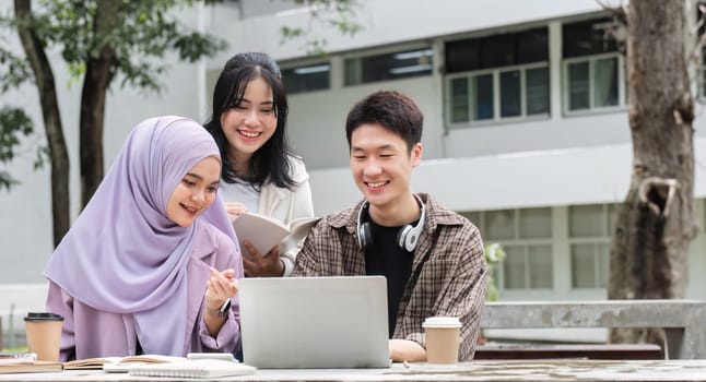 A multiracial group of students at the college, including Muslim and Asian students, sat on benches in a campus break area. Read books or study for exams together..