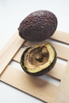 A rotten avocado on a white background