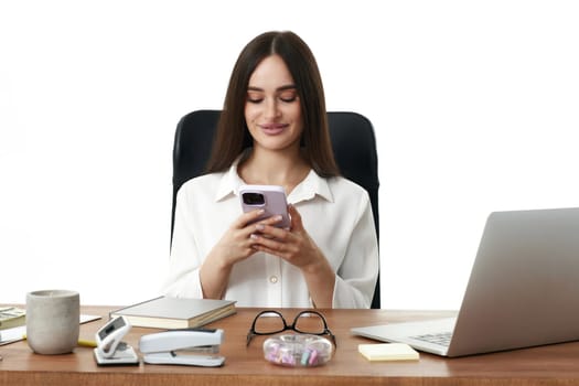 positive business woman using phone in the office