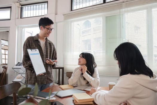 Cheerful young businessman meeting with business people at conference room at office, group of business people working at conference room.