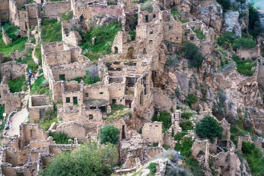 Dagestan Gamsutl. Ancient ghost town of Gamsutl old stone houses in abandoned Gamsutl mountain village in Dagestan, Abandoned etnic aul, summer landscape