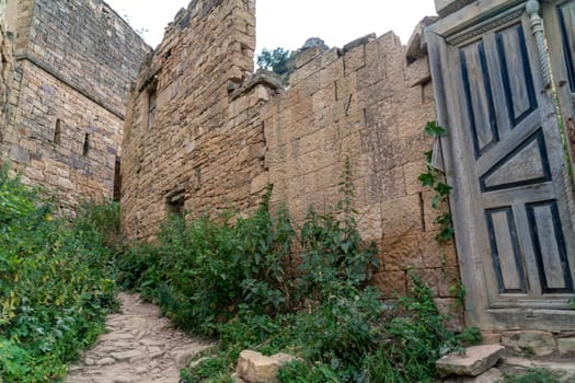 Dagestan Gamsutl. Ancient ghost town of Gamsutl old stone houses in abandoned Gamsutl mountain village in Dagestan, Abandoned etnic aul, summer landscape