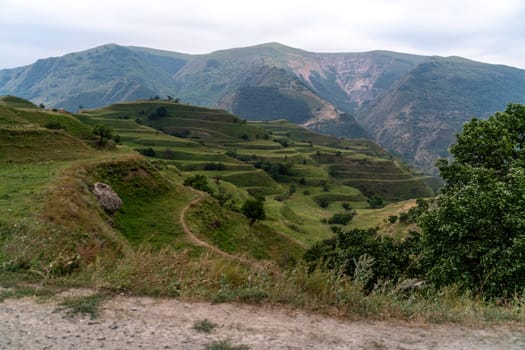 Chokhsky terraces Dagestan. Landscape of mountainous Dagestan with terraced fields and peaks mountains in the distance