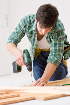 Home improvement - handyman installing wooden floor