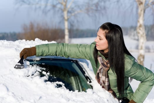 Winter car - woman remove snow from windshield