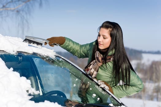 Winter car - woman remove snow from windshield
